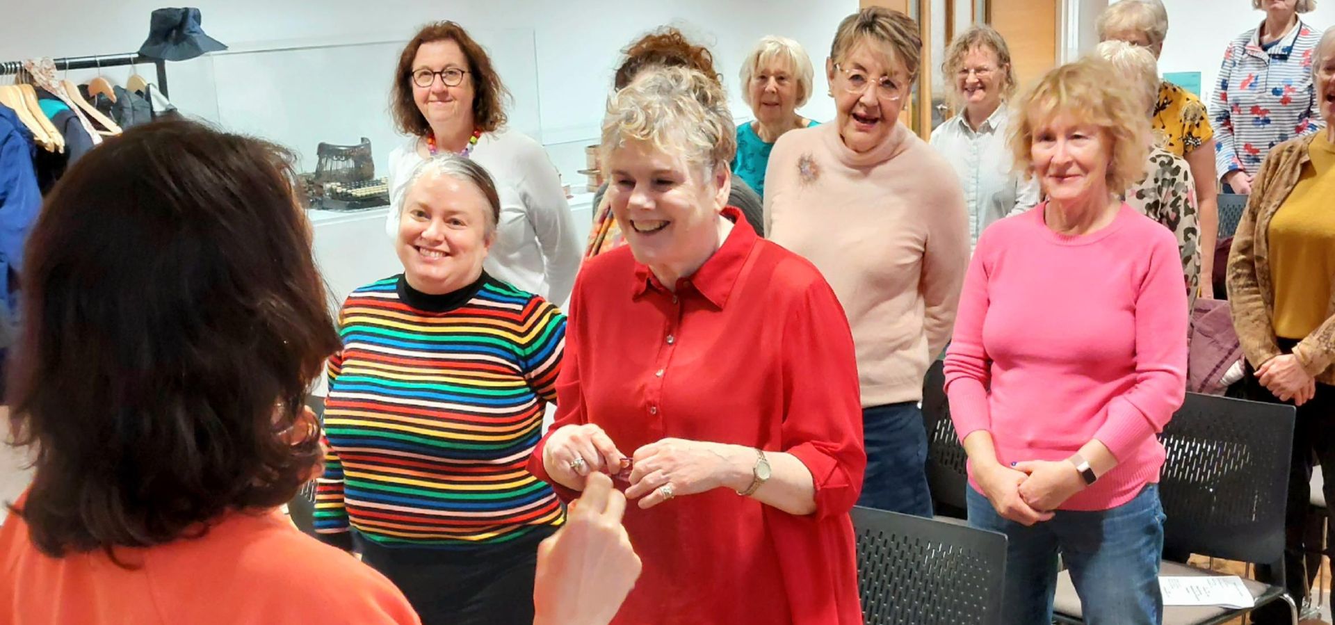 A community group at Leeds City Museum singing as a choir