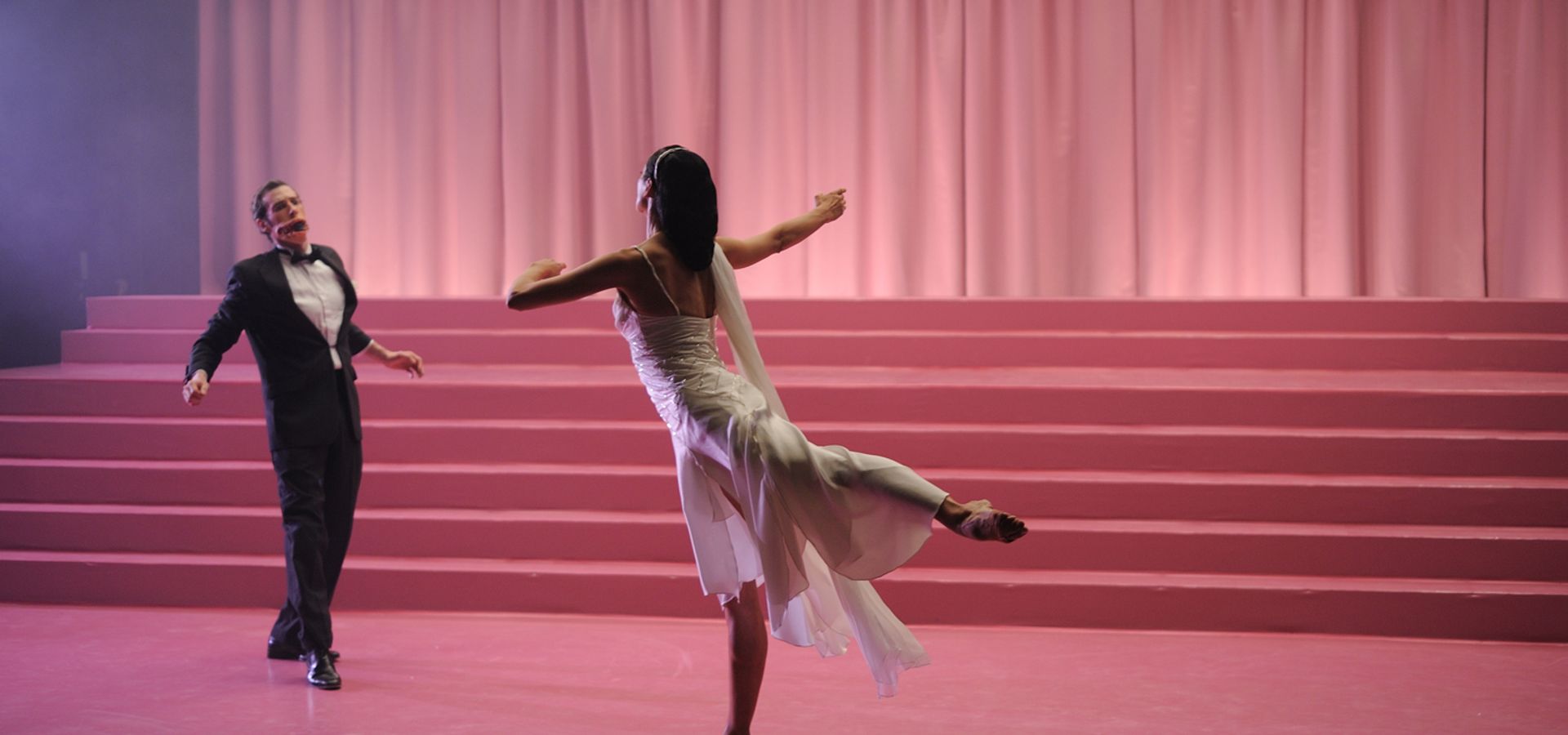 still image from Stuart Croft work, two dancers in front of a pink background