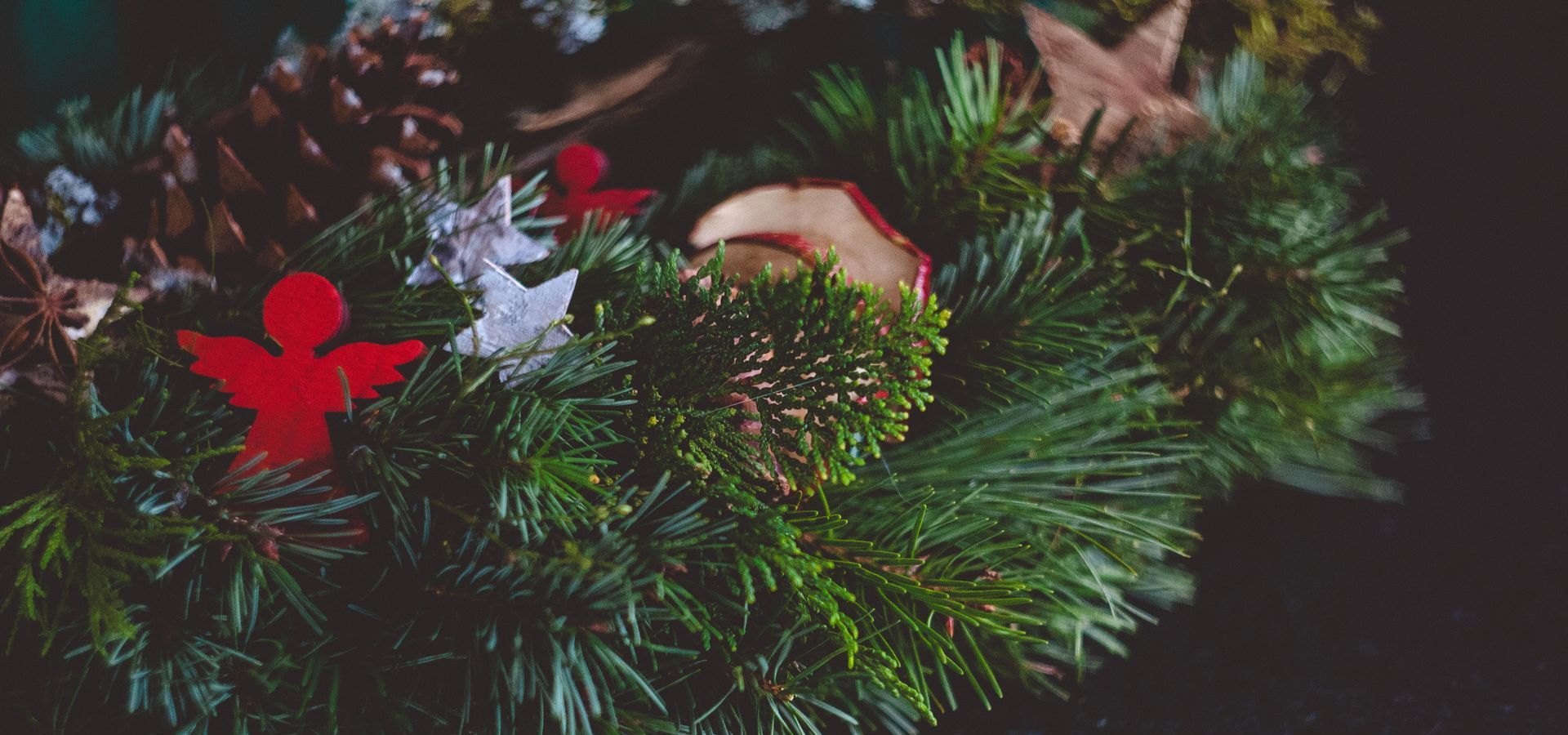 Green wreath with small decorated items placed on top