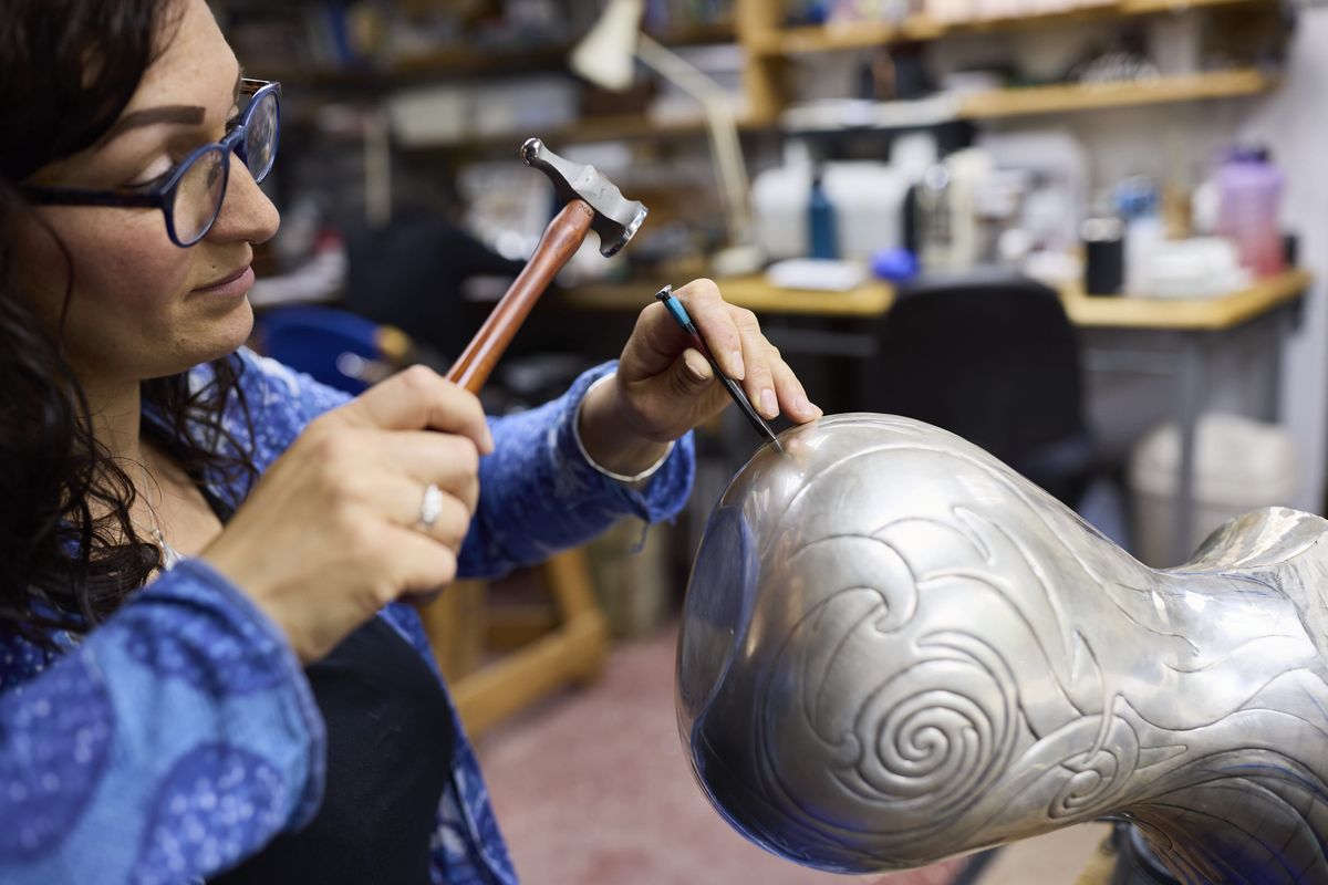 Miriam Handid carving silver in her in her studio