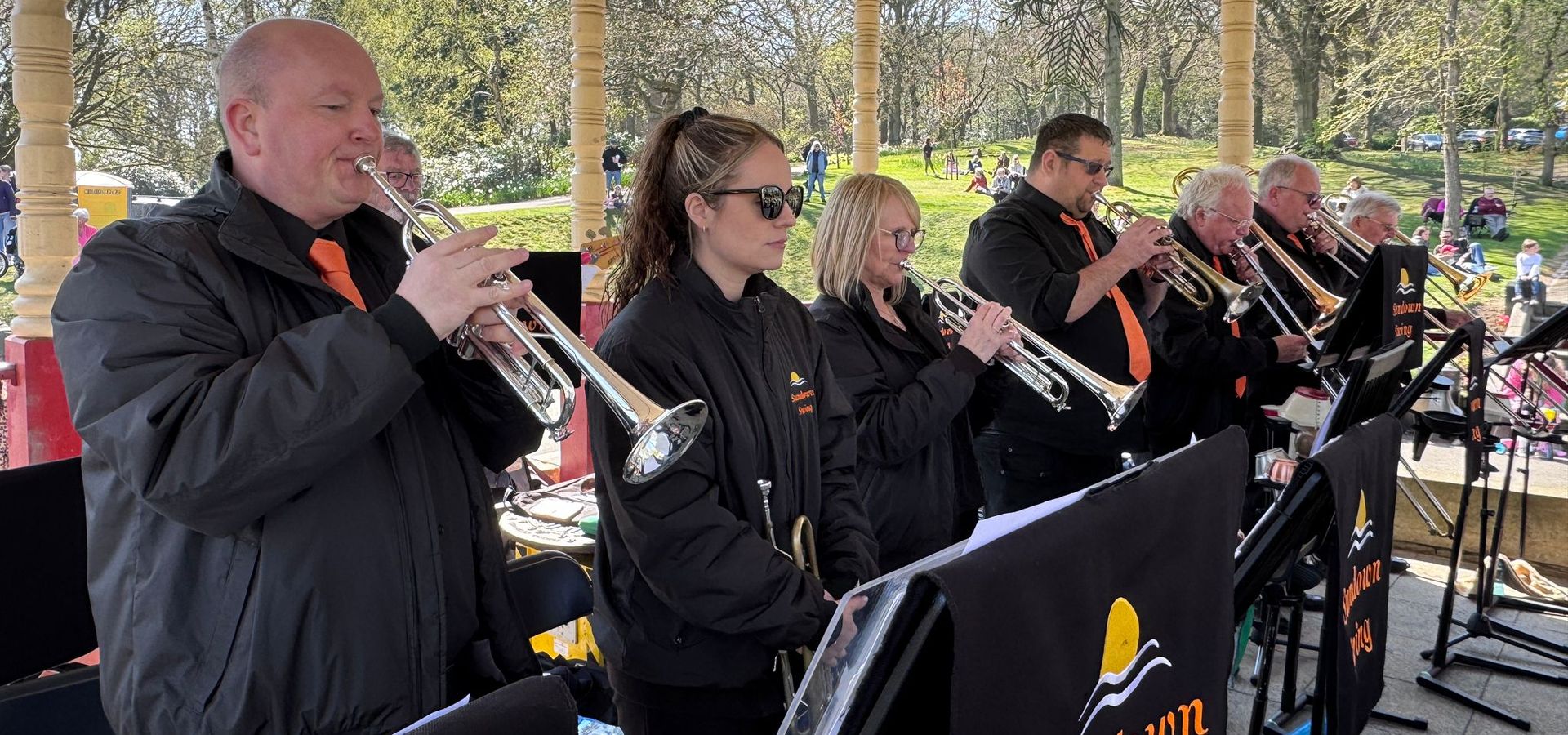 A brass band called the sundown swing playing in a tent