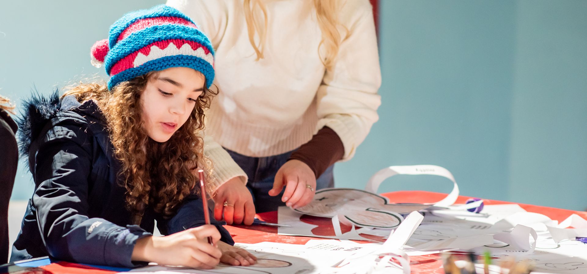 A child and parent taking part in craft activities at the museum