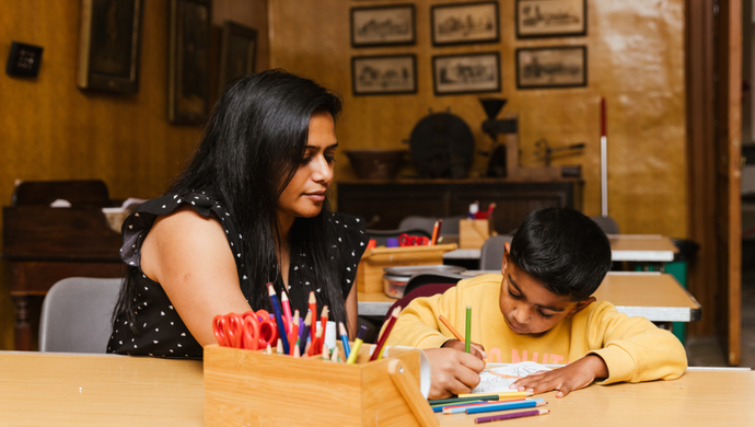 Adult and child doing colouring activity int he craft space at Temple Newsam