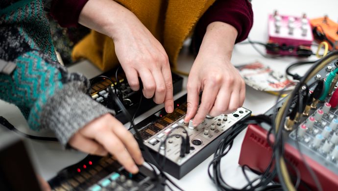 Two people using musical PA equipment 