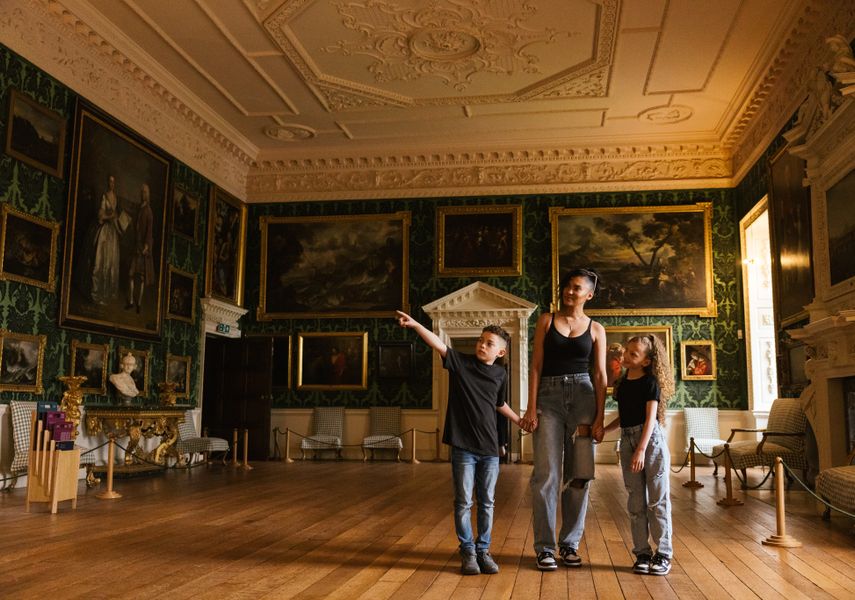 An adult and 2 children looking around Temple Newsam's Picture Gallery