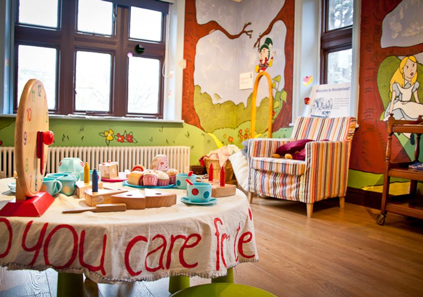 Table laid with toy cakes and teacups