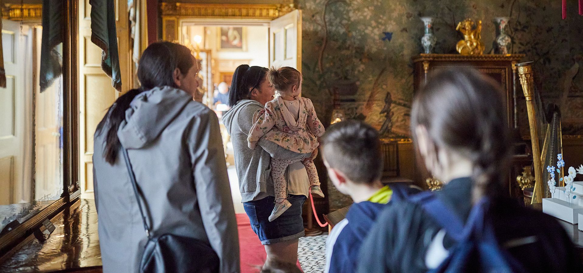 A family looking around temple newsam house