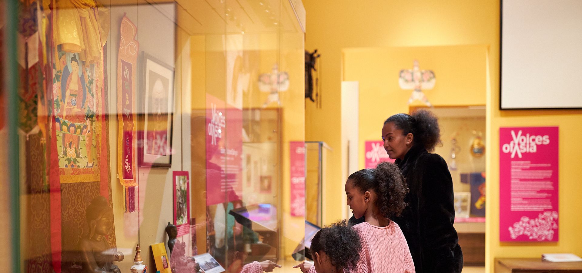 A family look around the Voices of Asia gallery at Leeds City Museum.