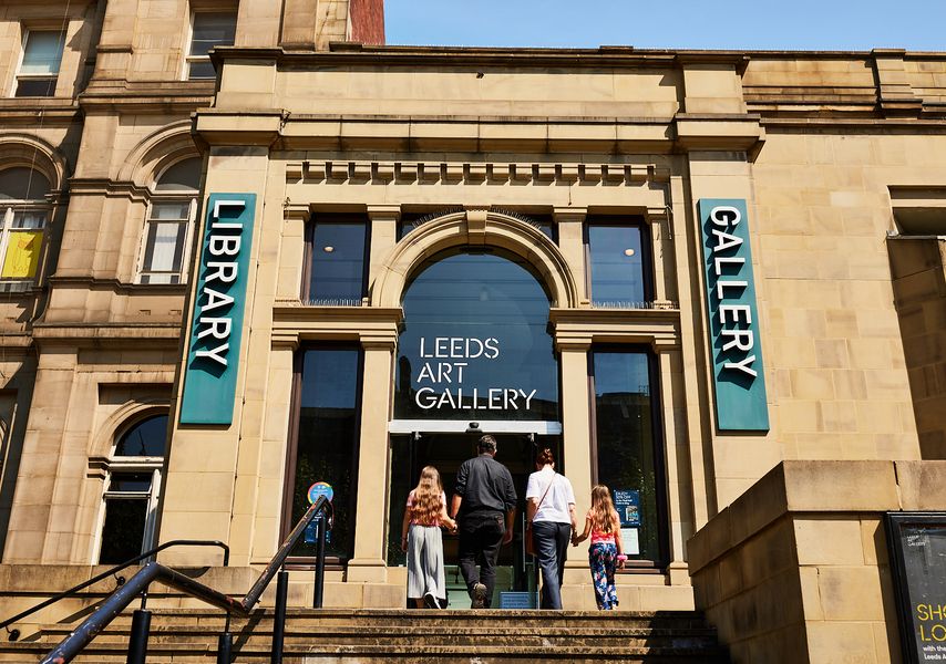 Family walking into the main entrance of Leeds Art Gallery