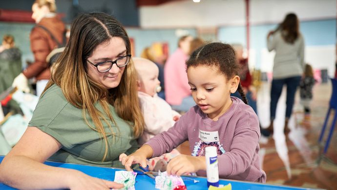 A mum and daughter crafting at a table
