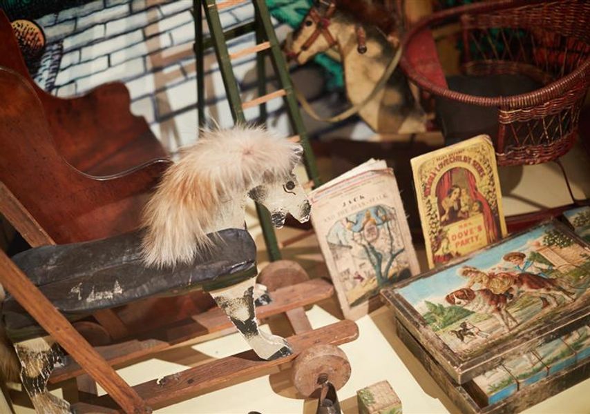 A rocking horse and old books and games at Abbey House Museum