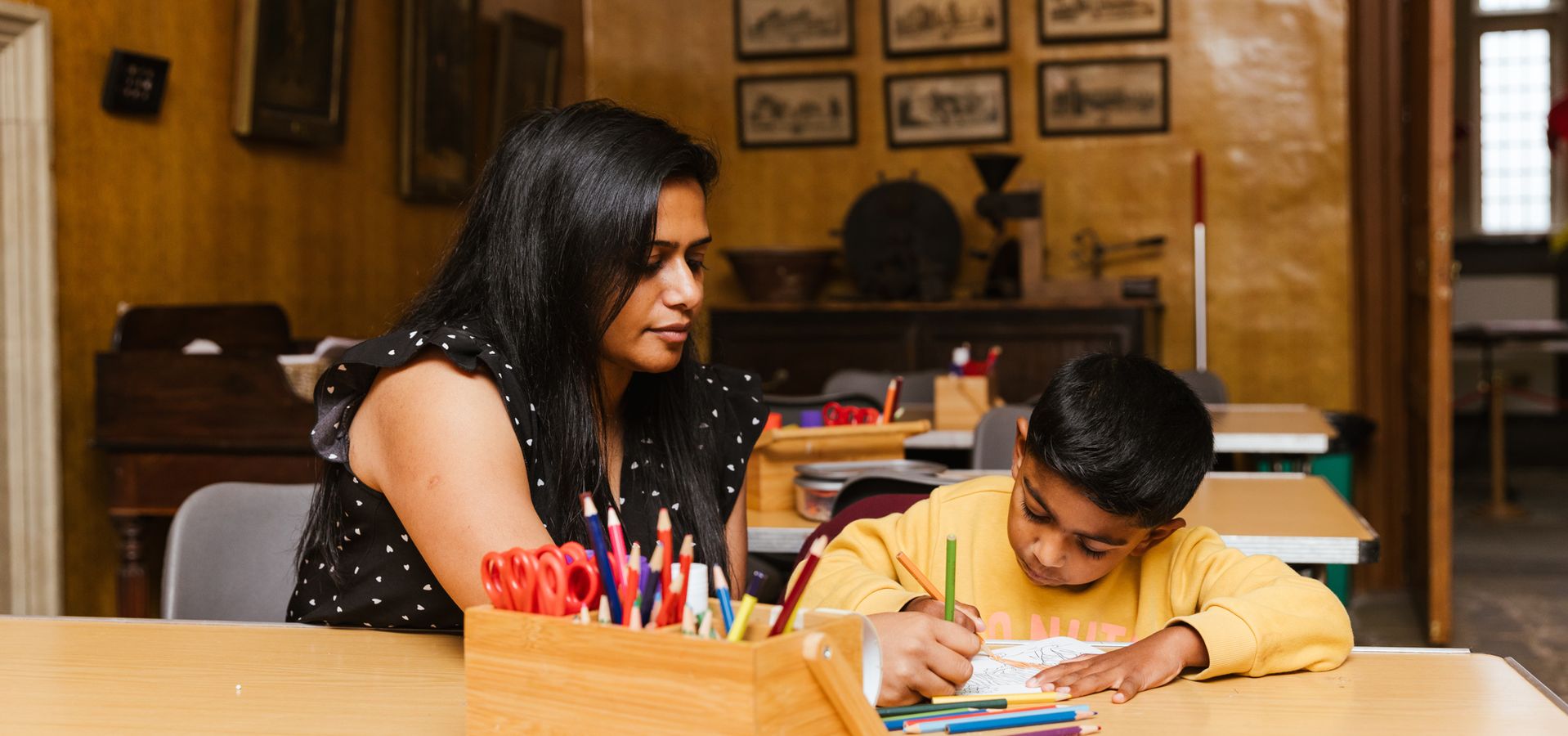 A parent and child drawing in the craft room in Temple Newsam House