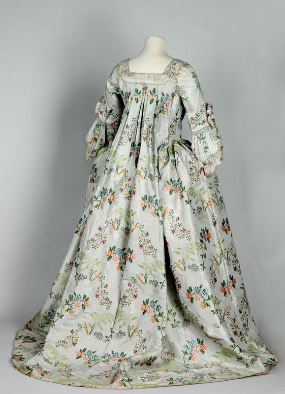 18th century dress made from high-quality, intricate silk fabrics woven in the Spitalfields district of East London, from behind