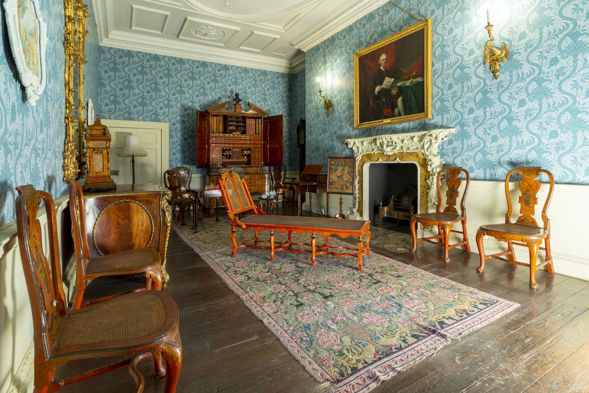 A white and blue room with wooden furniture in Temple Newsam
