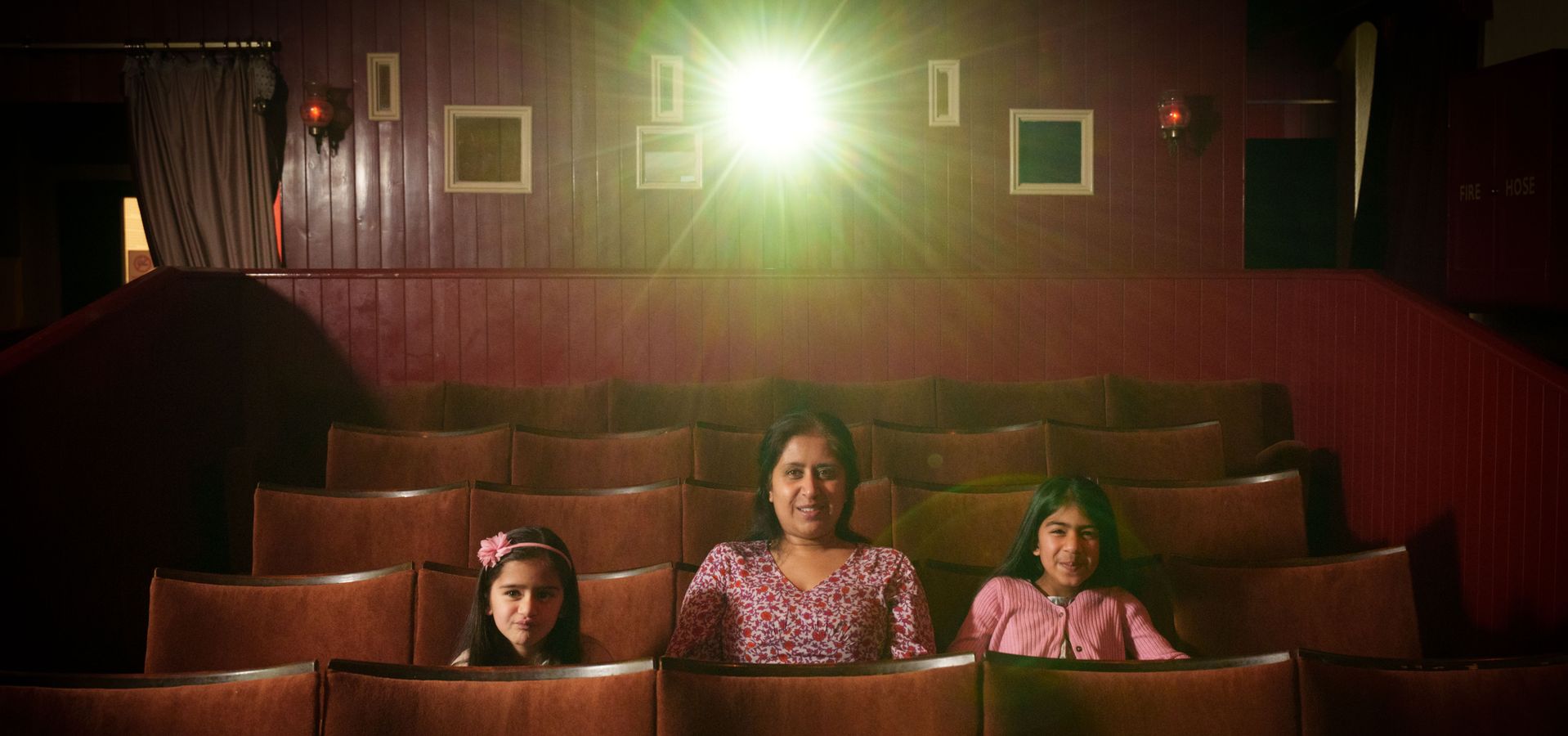 Family sitting in a small cinema