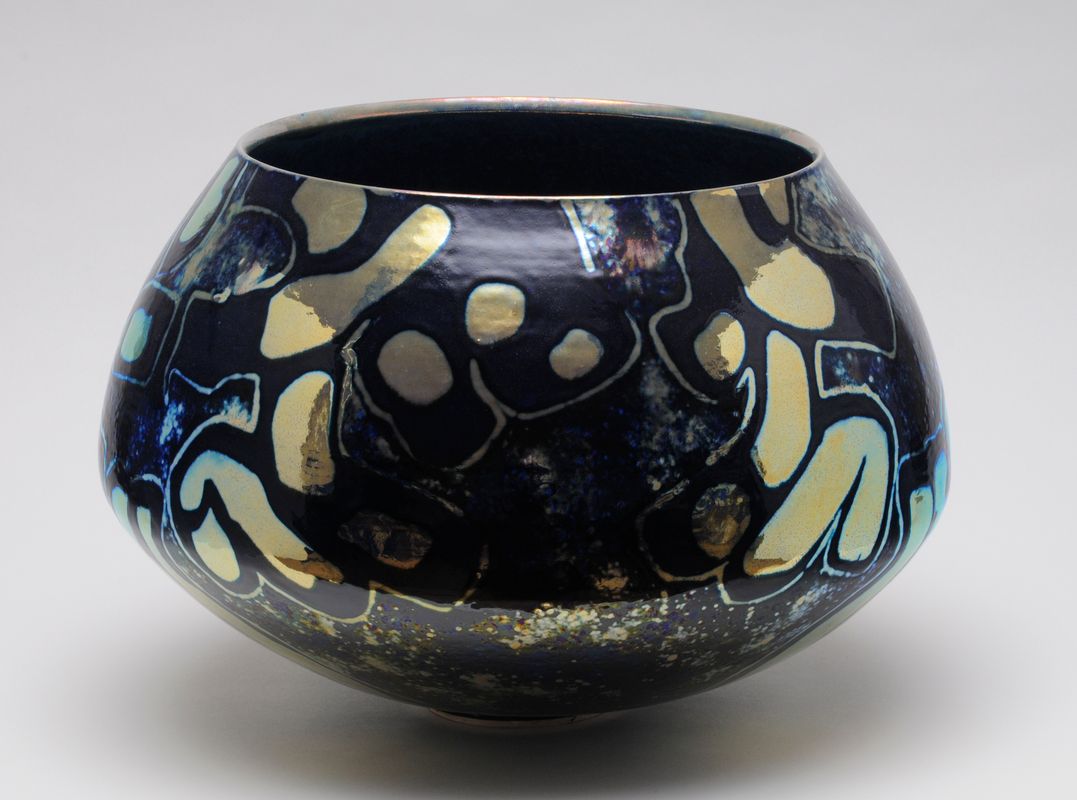 A back bowl with gold abstract shapes one