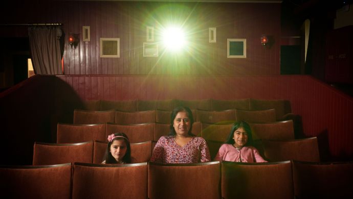 Family sitting in a small cinema