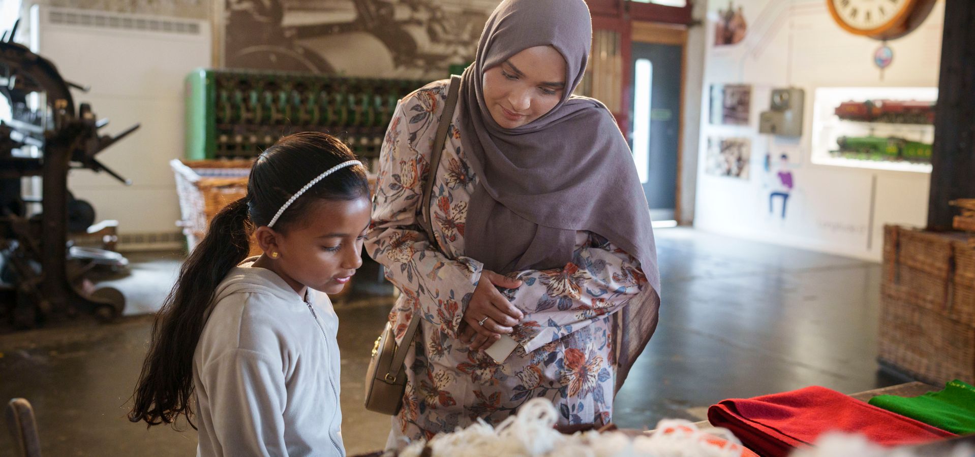 An adult and child looking at a wool exhibition display