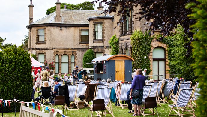 Families sat on seats outside Lotherton in the gardens
