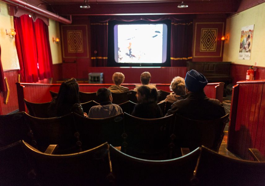 Two women and a toddler on cinema seats