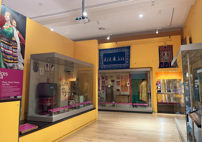 Displays within the Voices of Asia showing clothes and artefacts from Asian countries.