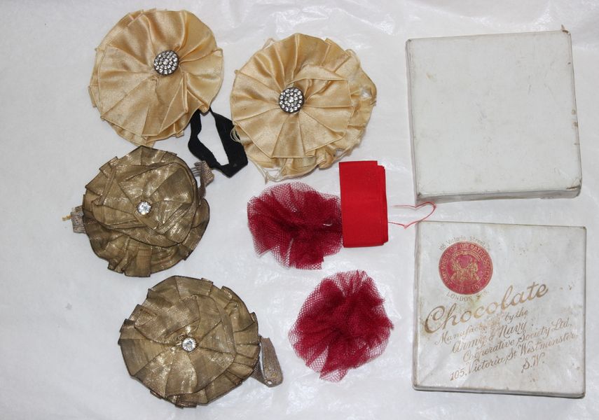 Photograph of ribbons and buttons, stored inside an old chocolate box