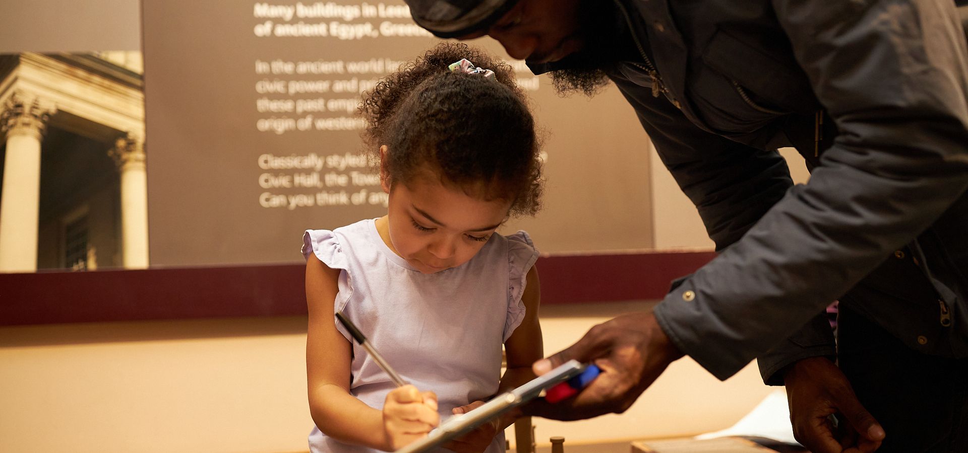 young girl in museum with father