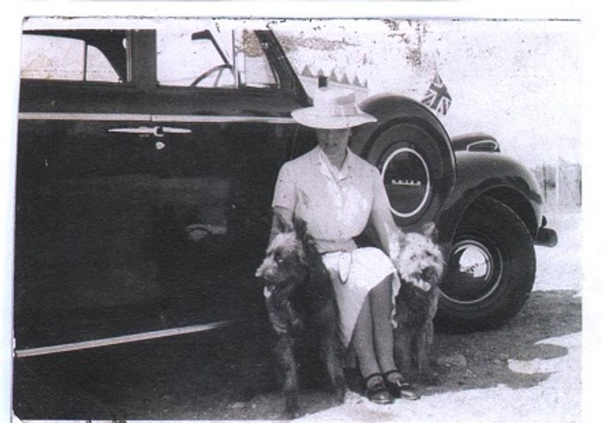 An old photo of a woman and her two dogs