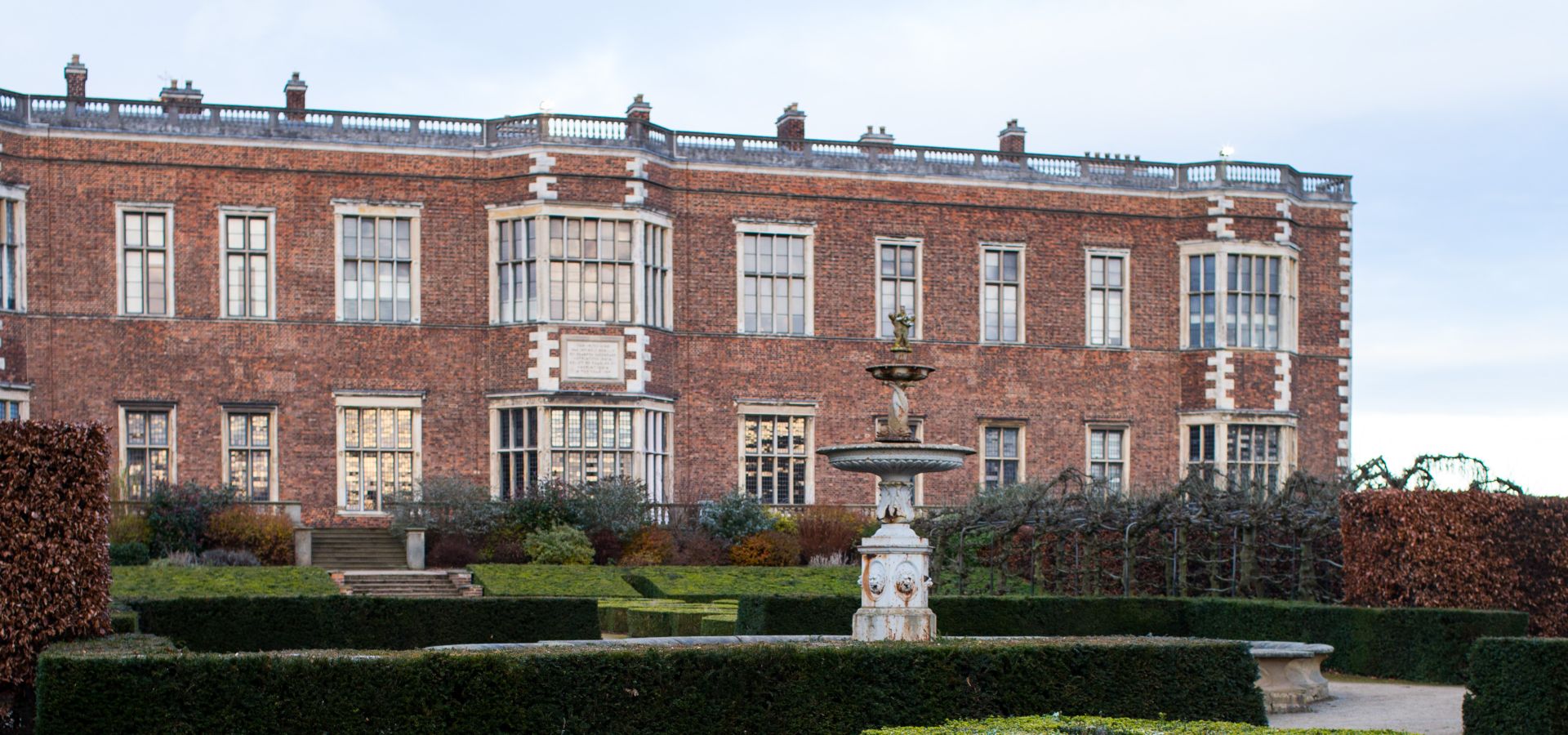The view of Temple Newsam house across hedges in the garden