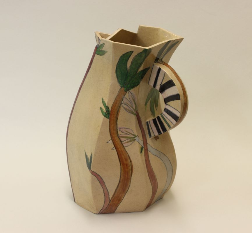 A clay ceramic pot with a handle with drawings and paintings of branches on