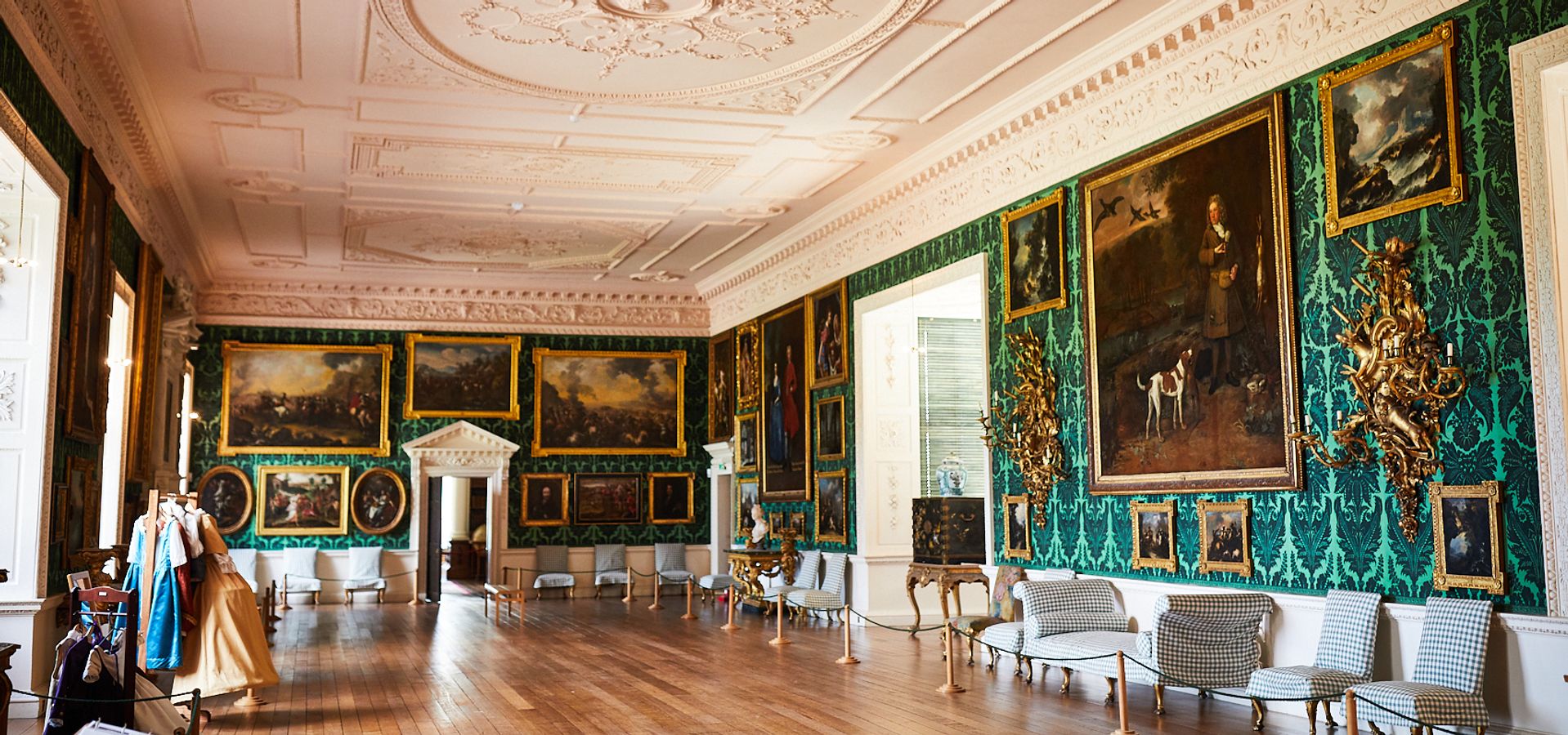 The Picture Gallery at Temple Newsam, with green wallpaper, a white ceiling and wooden floors