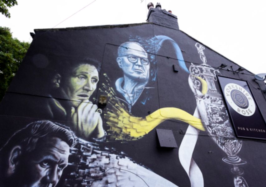 A mural of sporting people in Leeds on a building