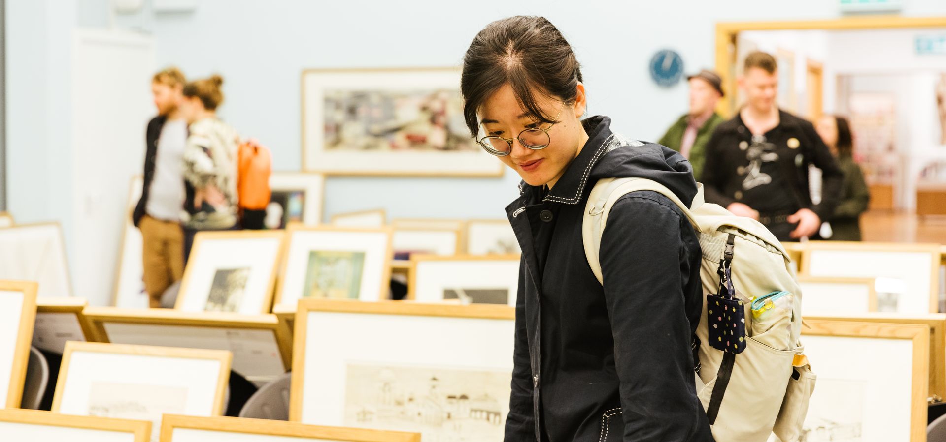 A person looks at art in the picture library 