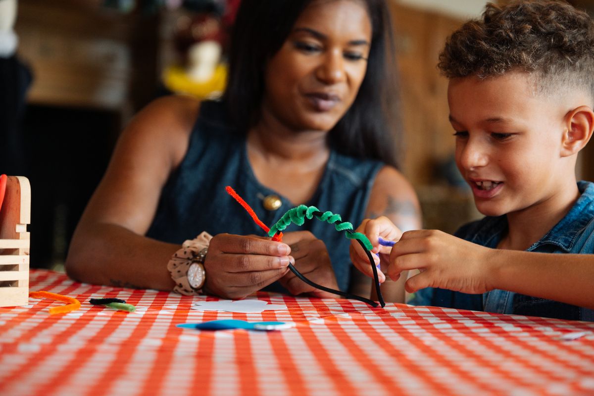 Young child with adult crafting a headband
