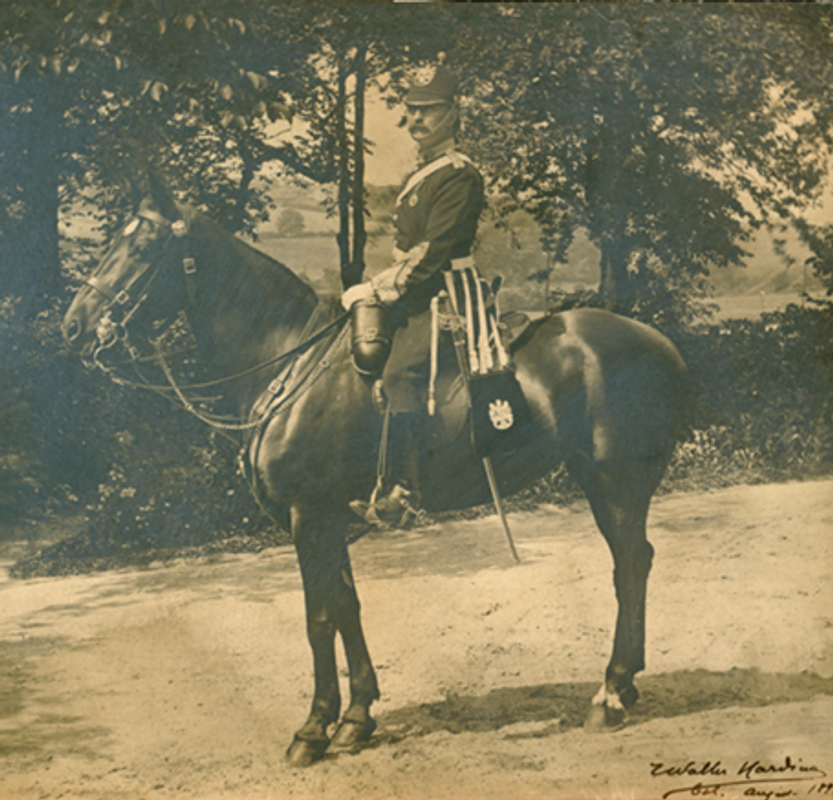 A black and white image of Colonel T Walter Harding riding a house on the grounds of Abbey House in 1893