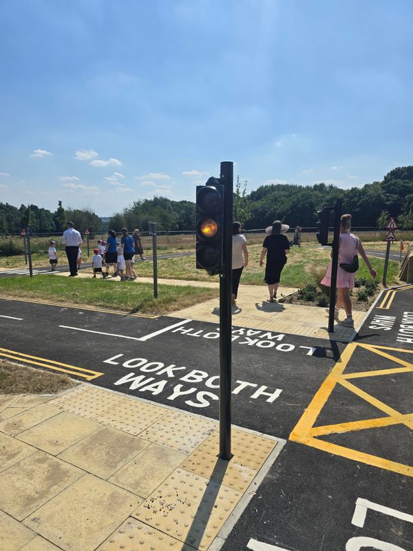 Adults and children looking around the learn to ride area