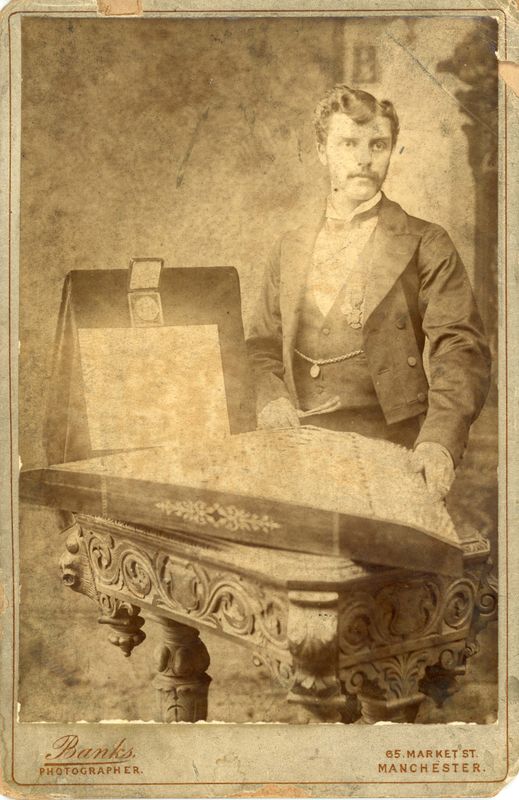 Photograph of W. S. Meeson with his dulcimer,  certificate, and medal. 