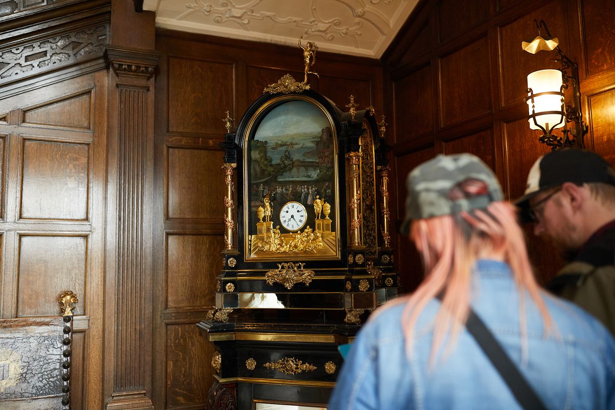 Two adults looking at an ornate clock in Temple Newsam