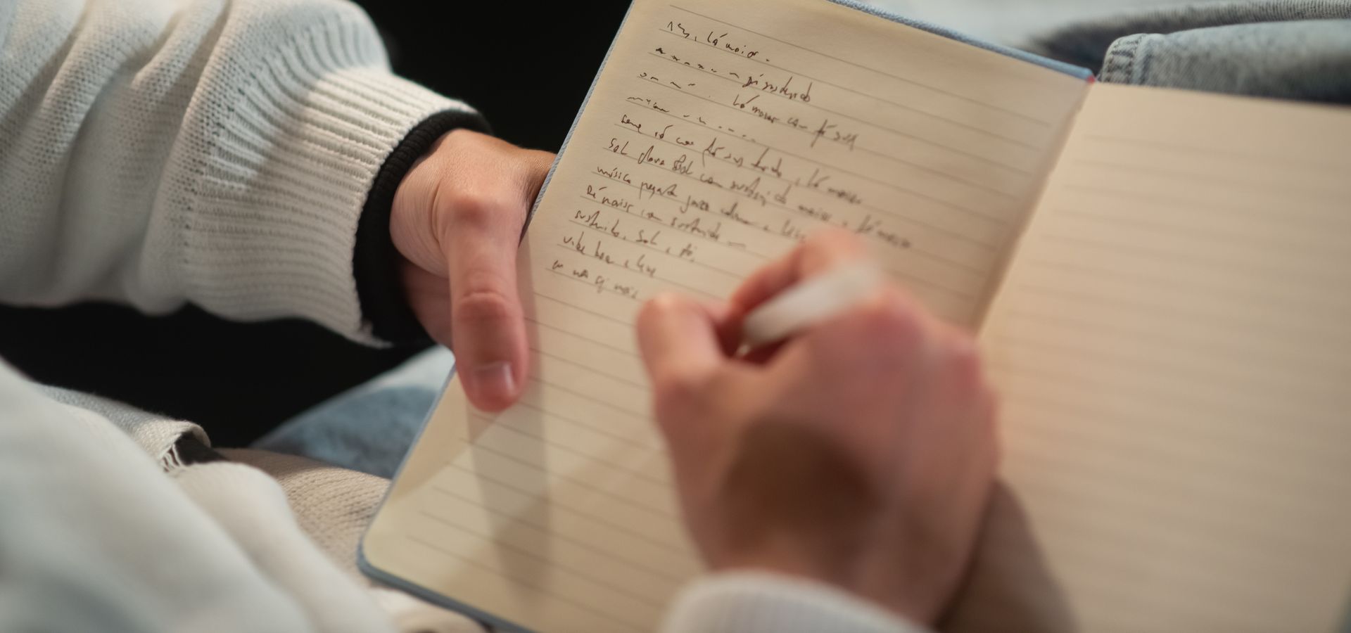 A person writing in a notebook