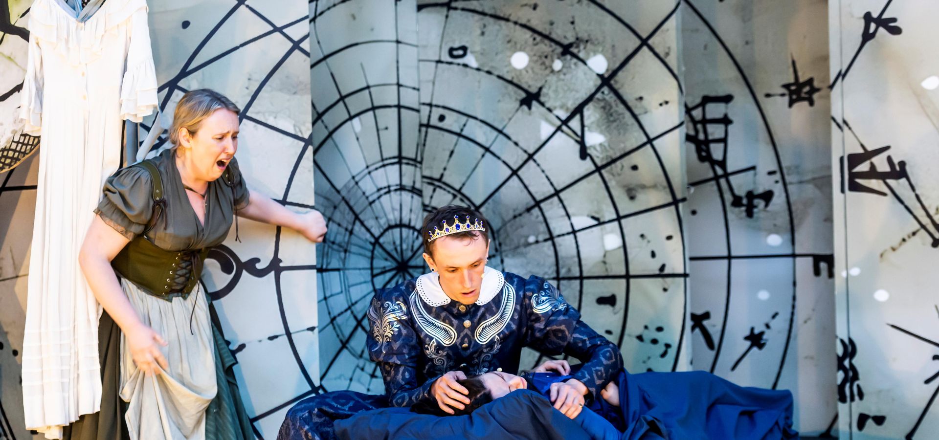 An actor, actress and child performing Romeo and Juliet