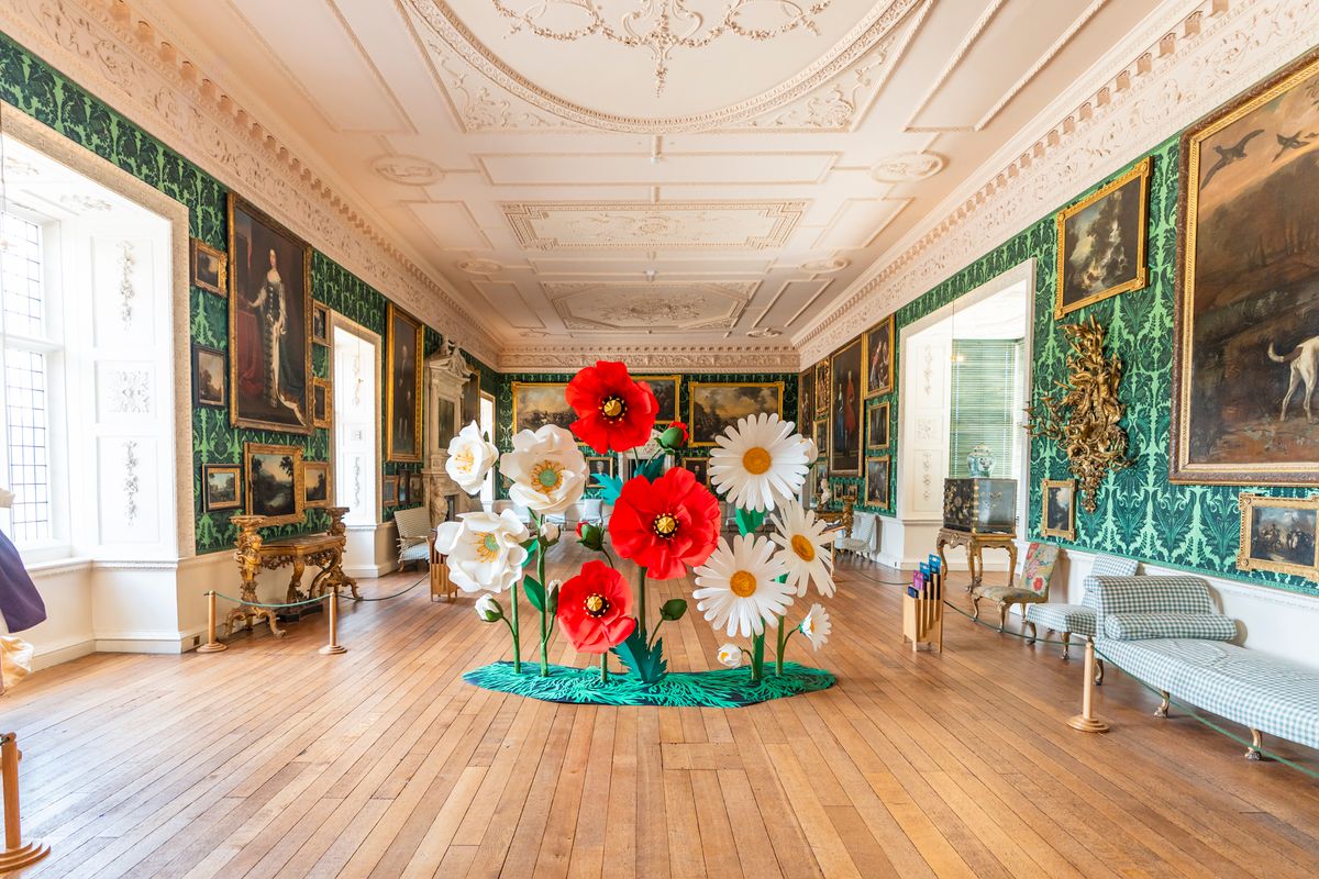 A flower sculpture with 3 red poppies, 3 daisies and 3 white flowers in The Picture Gallery