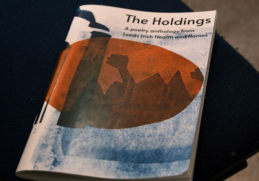 Cover of poetry book with art of a mill in an orange circle