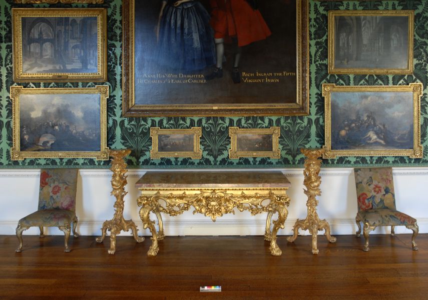 a console table with the face of Pan in the centre