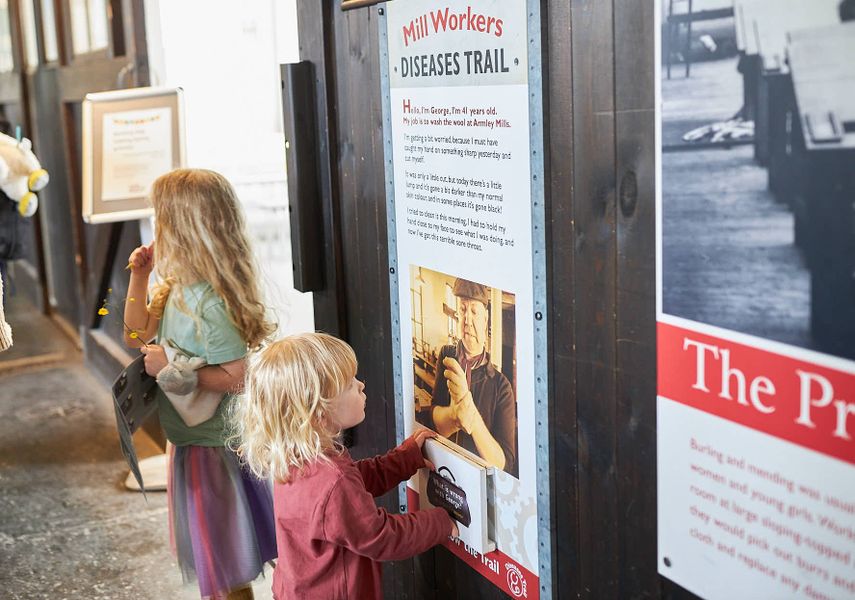 Two children looking at text panels in Leeds Industrial Museum