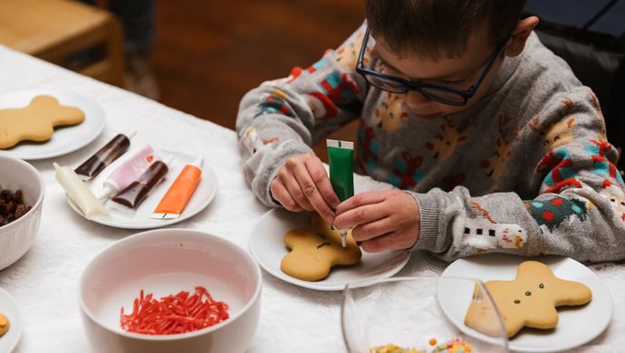 A child decorating ginger bread cookies