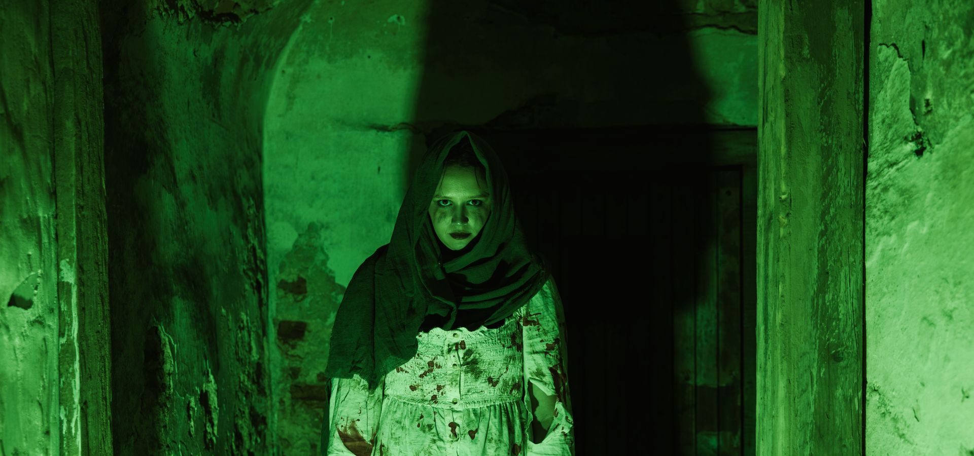 A costumed figure covered in blood in the spooky cellars at Temple Newsam