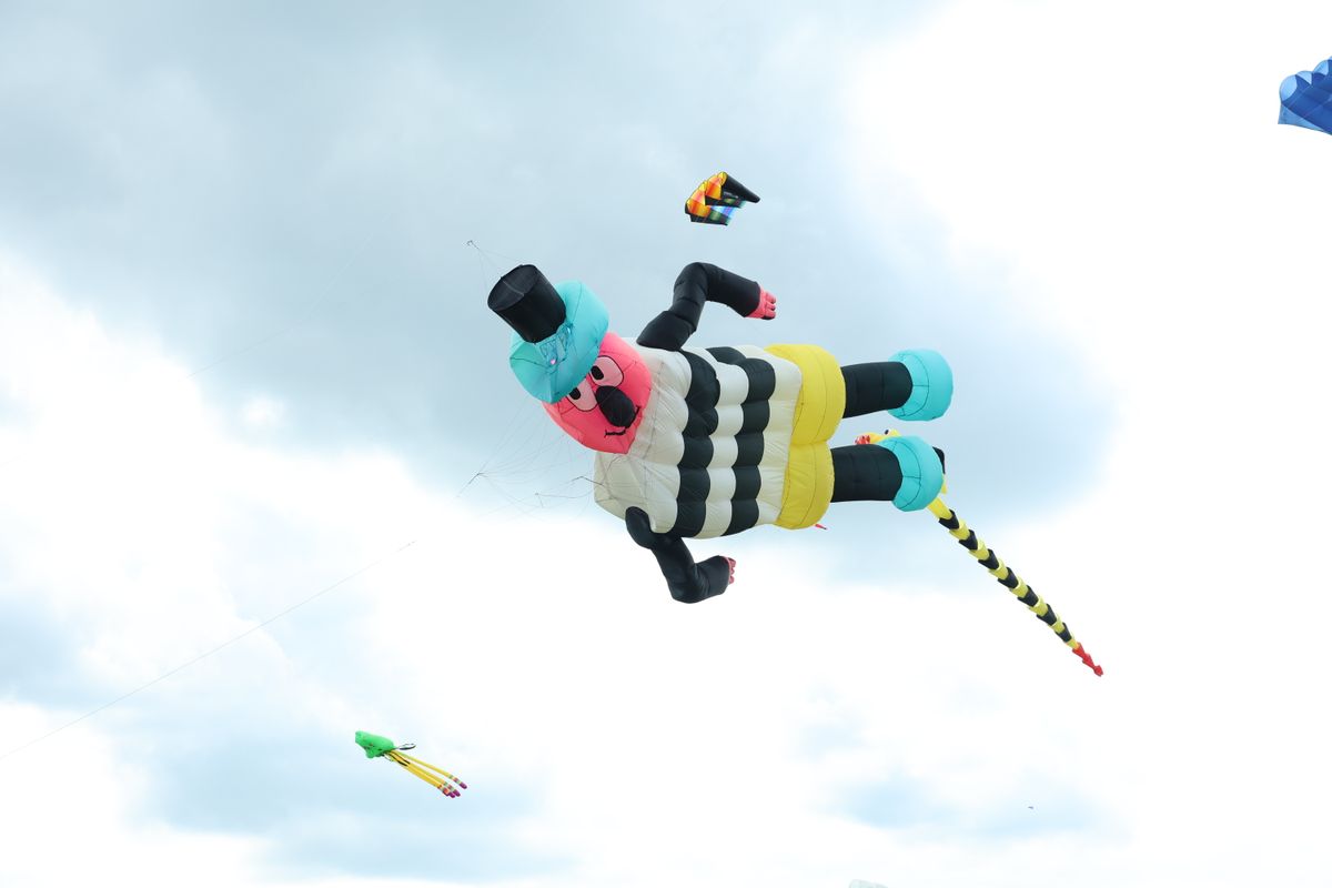 A liquorice sweet man as a kite in the sky