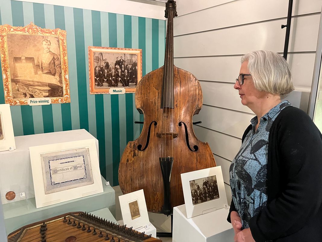 Curator Kitty Ross with a beautiful double bass manufactured by Leeds craftsman Mark William Dearlove, who was violin and bass maker for the Great Industrial Exhibition of all Nations, Crystal Palace, London 1851.