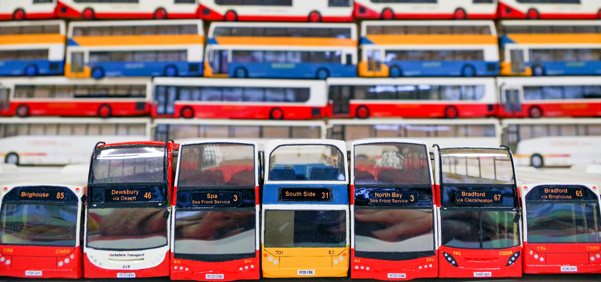 Rows of coloured bus models