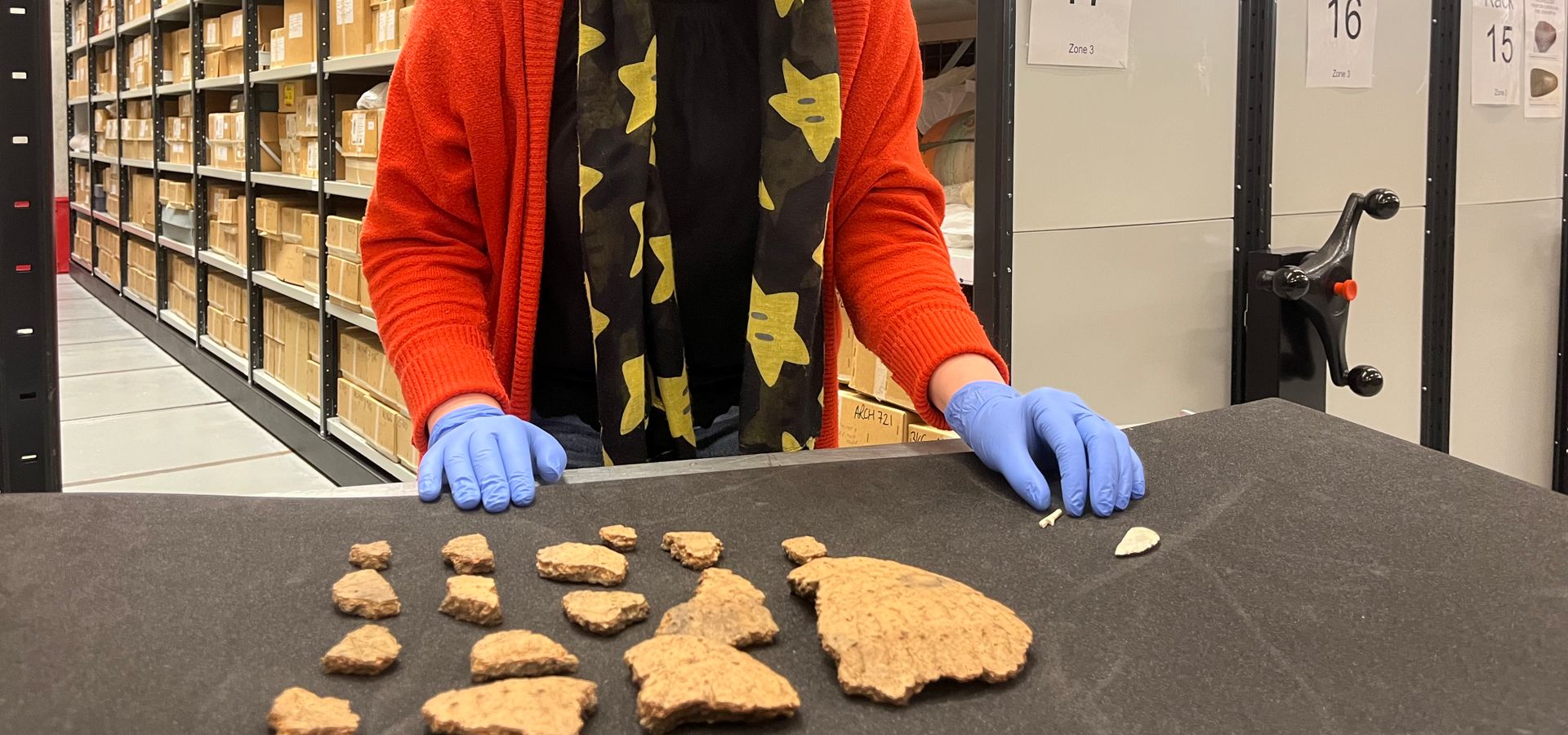 Kat Baxter, Leeds Museums and Galleries’ curator of archaeology, with some of the ancient Bronze Age finds made at Pitty Close Farm in Drighlington, Leeds.